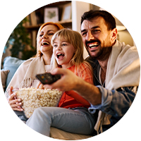 Family sitting together on their couch streaming television