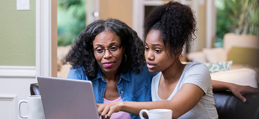 two women viewing laptop