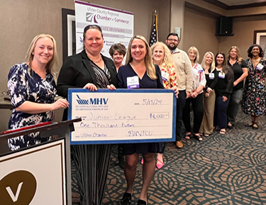 MHV staff presenting a check at Ulster Chamber breakfast