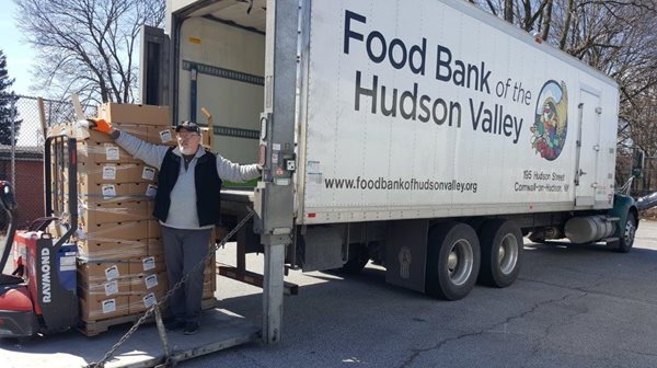 Man unloading boxes from the Food Bank of the Hudson Valley truck.