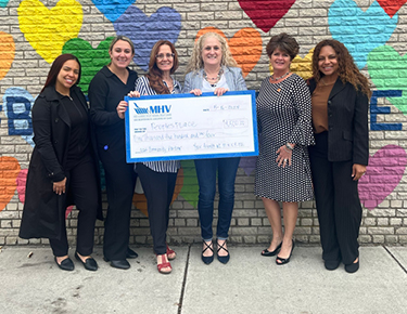 MHV presenting check at People's Place