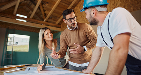 Young couple working with contractor on home